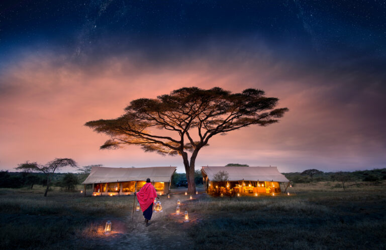 Tanzania serengeti under canvas suc guest area camp exterior with lantern walkway and maasai 2